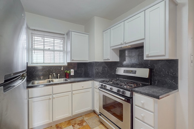 kitchen featuring decorative backsplash, sink, white cabinets, and appliances with stainless steel finishes