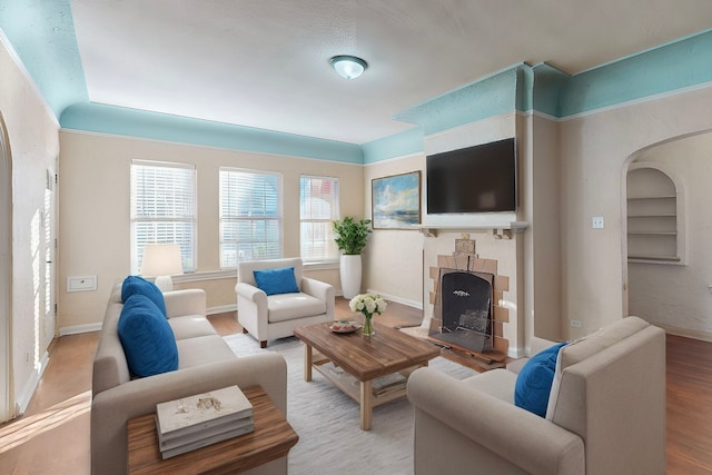 living room featuring hardwood / wood-style floors, a textured ceiling, and lofted ceiling