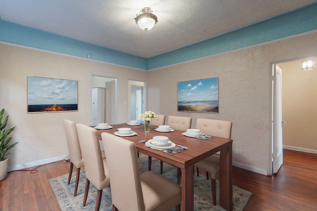 dining room featuring a textured ceiling and dark wood-type flooring