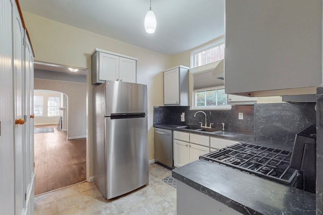 kitchen featuring hanging light fixtures, a healthy amount of sunlight, sink, and stainless steel appliances