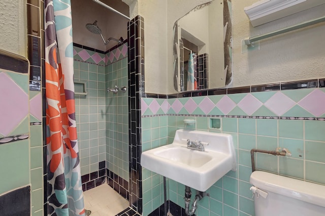 bathroom with curtained shower, toilet, and tile walls