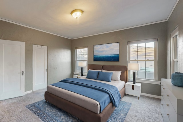 bedroom with ornamental molding and light carpet