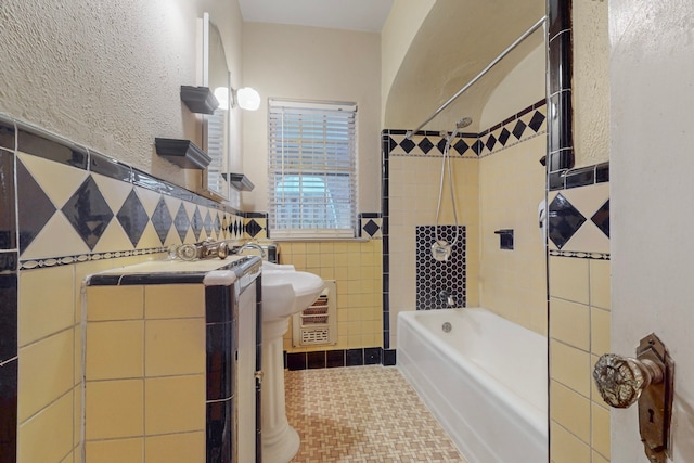 bathroom featuring tile patterned flooring and tile walls