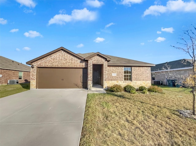 ranch-style house featuring a front lawn, central AC unit, and a garage