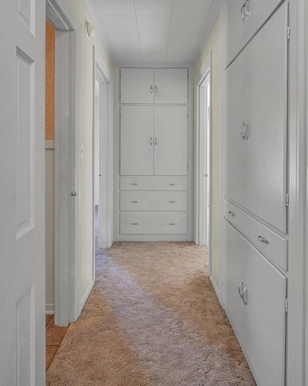 corridor with light colored carpet