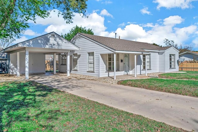 ranch-style house with a carport, a porch, and a front lawn