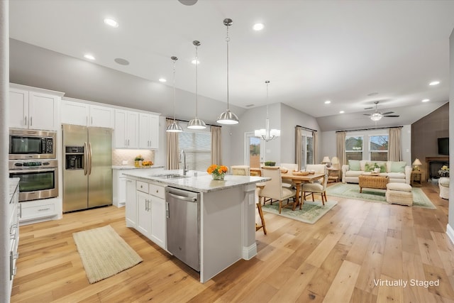 kitchen featuring white cabinetry, sink, appliances with stainless steel finishes, and light hardwood / wood-style flooring