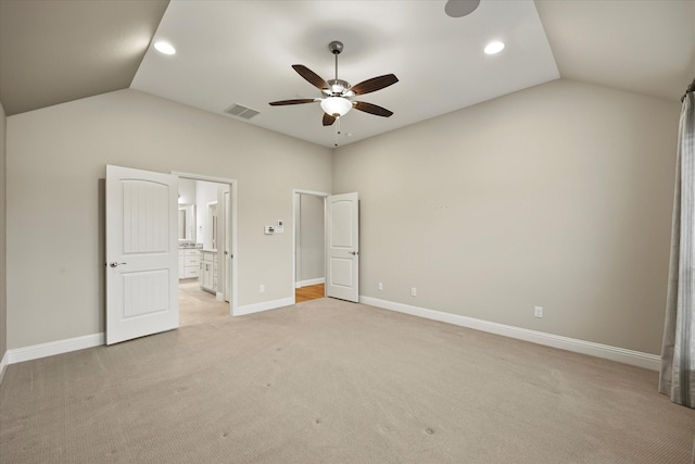 unfurnished bedroom with light colored carpet, ceiling fan, and lofted ceiling