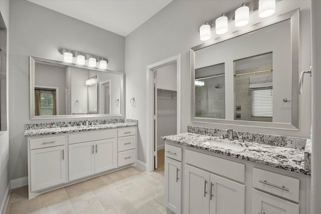 bathroom with vanity and tiled shower