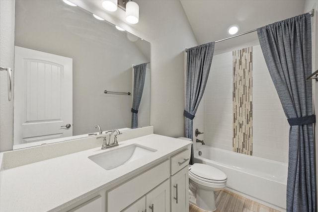 full bathroom with hardwood / wood-style flooring, vanity, shower / tub combo, and toilet