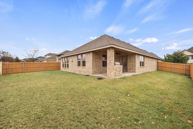 back of property featuring a yard and a patio