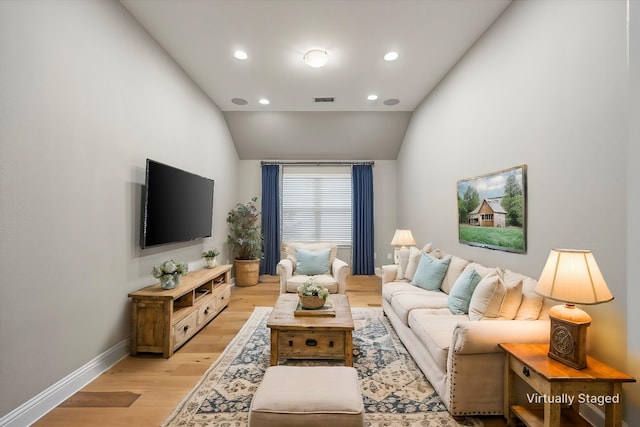 living room with light wood-type flooring and lofted ceiling