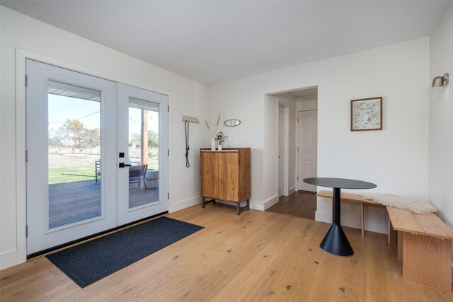 doorway with french doors and light hardwood / wood-style flooring