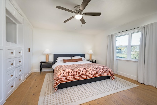 bedroom with ceiling fan and light hardwood / wood-style floors