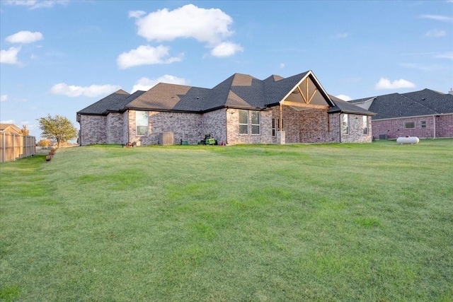 rear view of property featuring a lawn