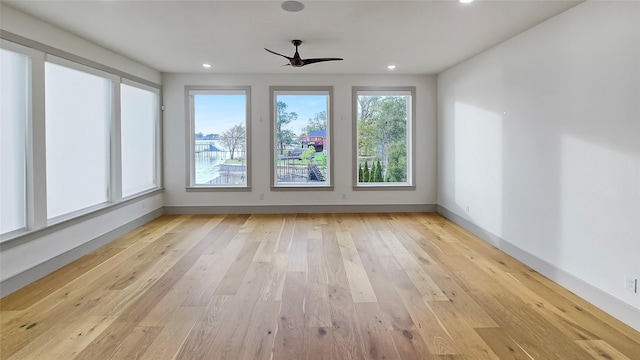 unfurnished room featuring ceiling fan and light hardwood / wood-style floors