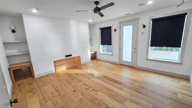 unfurnished living room with light hardwood / wood-style floors and ceiling fan