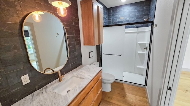 bathroom featuring decorative backsplash, hardwood / wood-style floors, and toilet