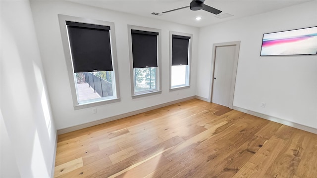 unfurnished room with ceiling fan and light wood-type flooring