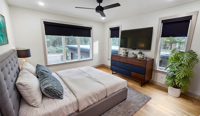 bedroom with ceiling fan and light hardwood / wood-style flooring