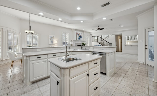 kitchen with sink, hanging light fixtures, stainless steel dishwasher, a kitchen island with sink, and ceiling fan with notable chandelier