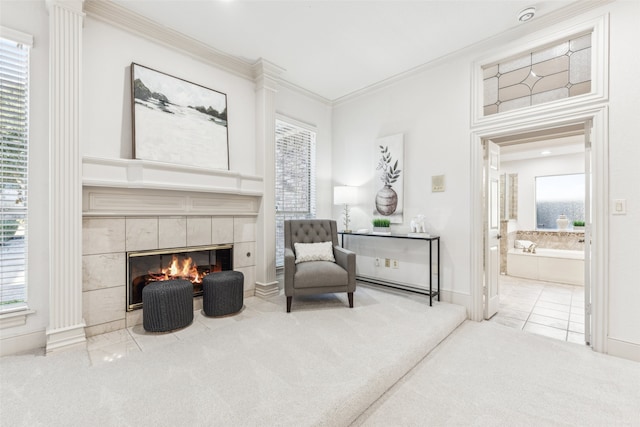 sitting room with ornamental molding, plenty of natural light, light carpet, and a fireplace