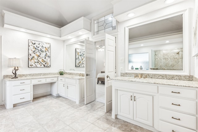 bathroom with ceiling fan, vanity, and a shower with shower door