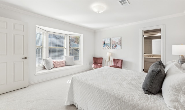 bedroom featuring crown molding, light carpet, and ensuite bath