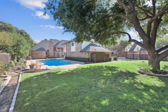 view of swimming pool with a yard