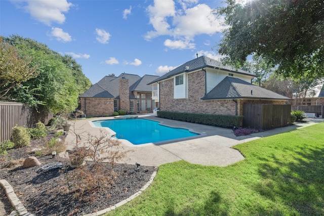 view of swimming pool featuring a yard and a patio