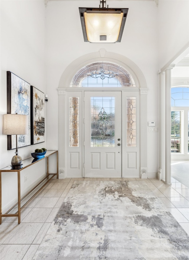 tiled entryway with a towering ceiling