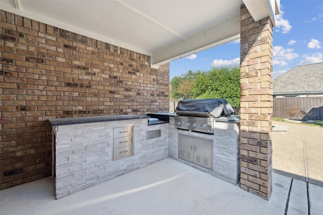 view of patio / terrace featuring exterior kitchen and grilling area