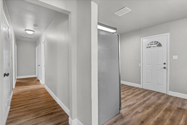 hallway with wood-type flooring