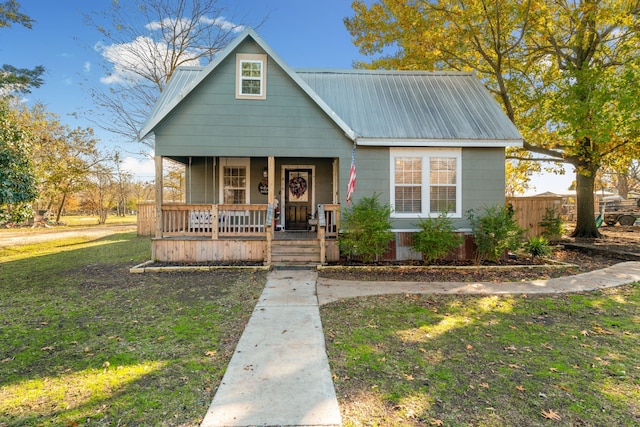 bungalow-style home with covered porch and a front lawn