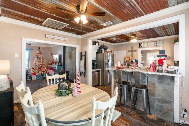 dining area with dark hardwood / wood-style floors and ornamental molding