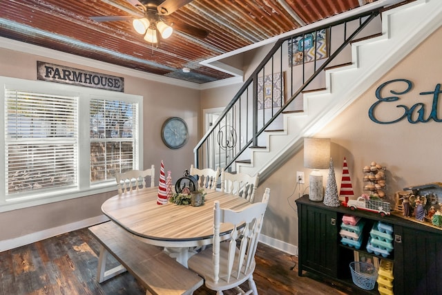 dining area featuring wood ceiling, ceiling fan, dark wood-type flooring, and ornamental molding