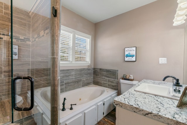 bathroom with hardwood / wood-style floors, a bathtub, toilet, and vanity