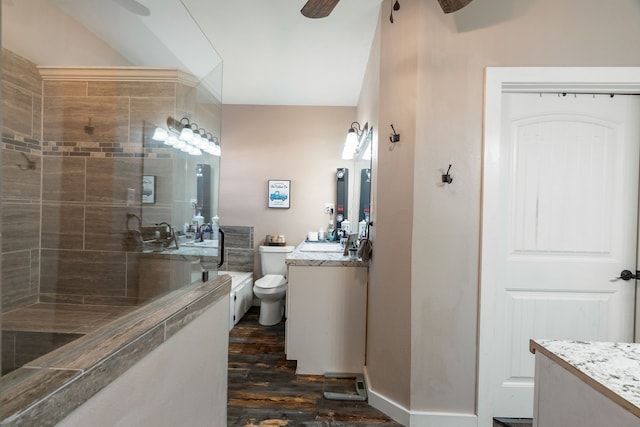 bathroom featuring ceiling fan, vanity, wood-type flooring, and toilet