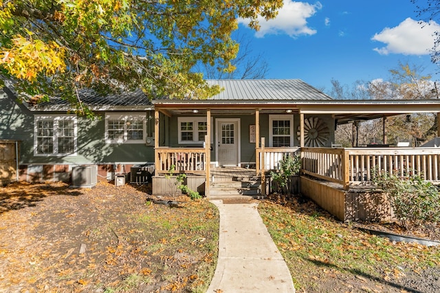 view of front of home with a porch and central AC unit