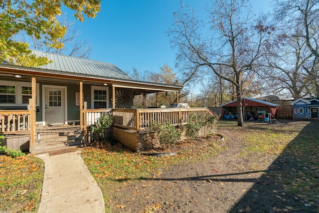 view of front of home featuring a porch and a shed