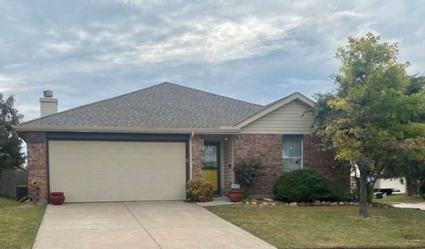 ranch-style home with a garage and a front yard