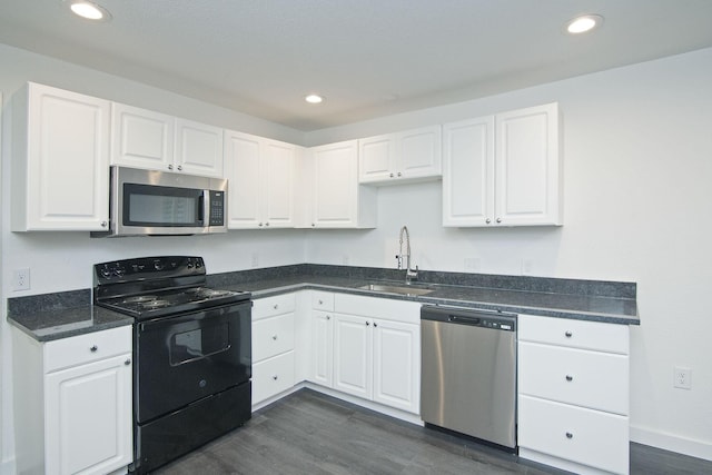 kitchen with white cabinetry, stainless steel appliances, dark hardwood / wood-style flooring, and sink