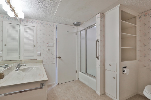 full bathroom with enclosed tub / shower combo, vanity, a textured ceiling, and toilet