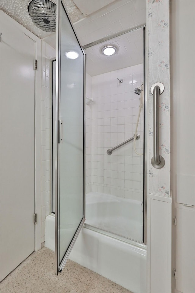 bathroom with bath / shower combo with glass door