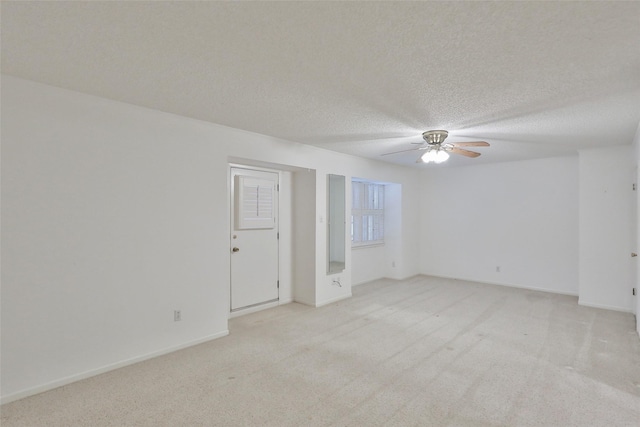 spare room with light carpet, a textured ceiling, and ceiling fan