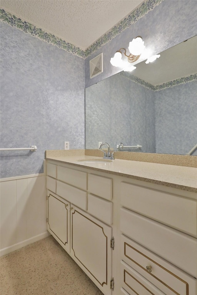 bathroom with vanity and a textured ceiling