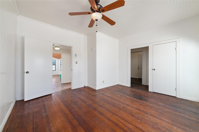 empty room with ceiling fan, dark hardwood / wood-style flooring, and ornamental molding