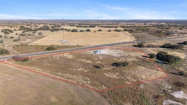 birds eye view of property with a rural view