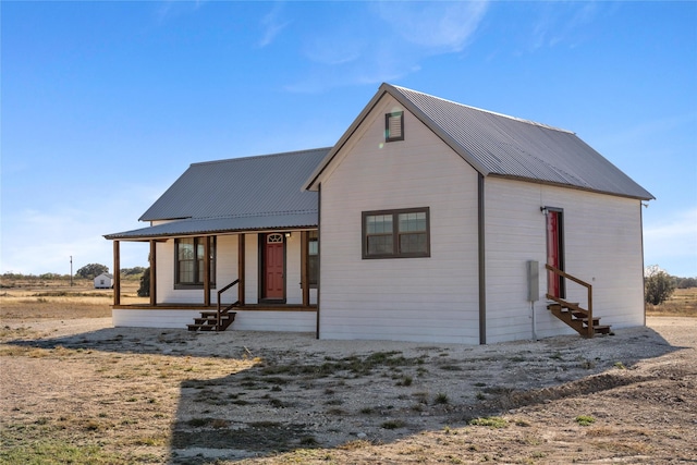 back of property with covered porch