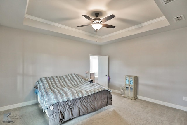 bedroom featuring a raised ceiling, ceiling fan, light colored carpet, and ornamental molding